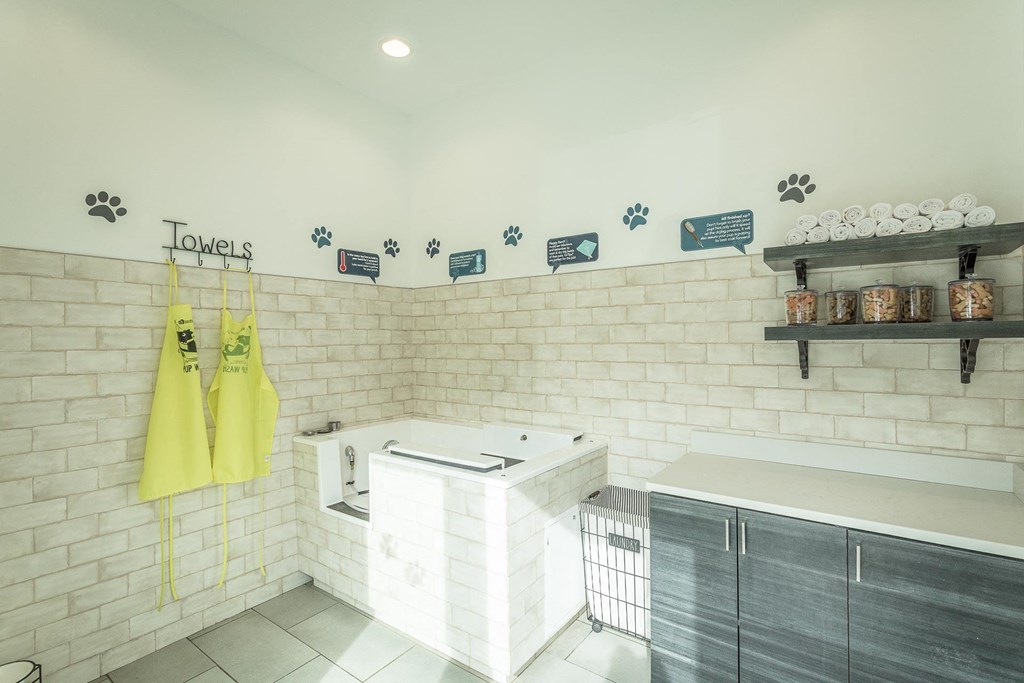 a small kitchen with a stove and a yellow towel on the wall