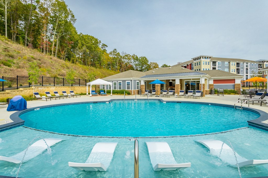 Amenities Highlight Resort Style Swimming Pool With Submerged Loungers