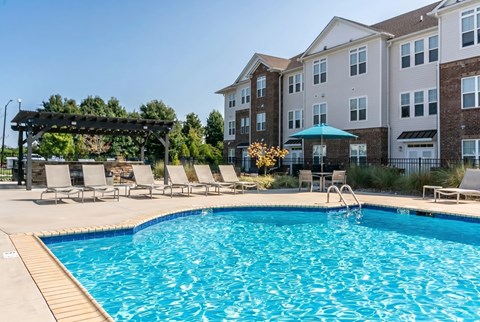 A swimming pool in front of a residential building.