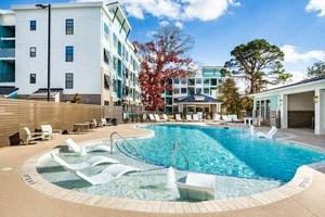 a swimming pool at a resort with an apartment building