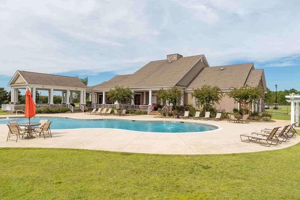 a large swimming pool in front of a house