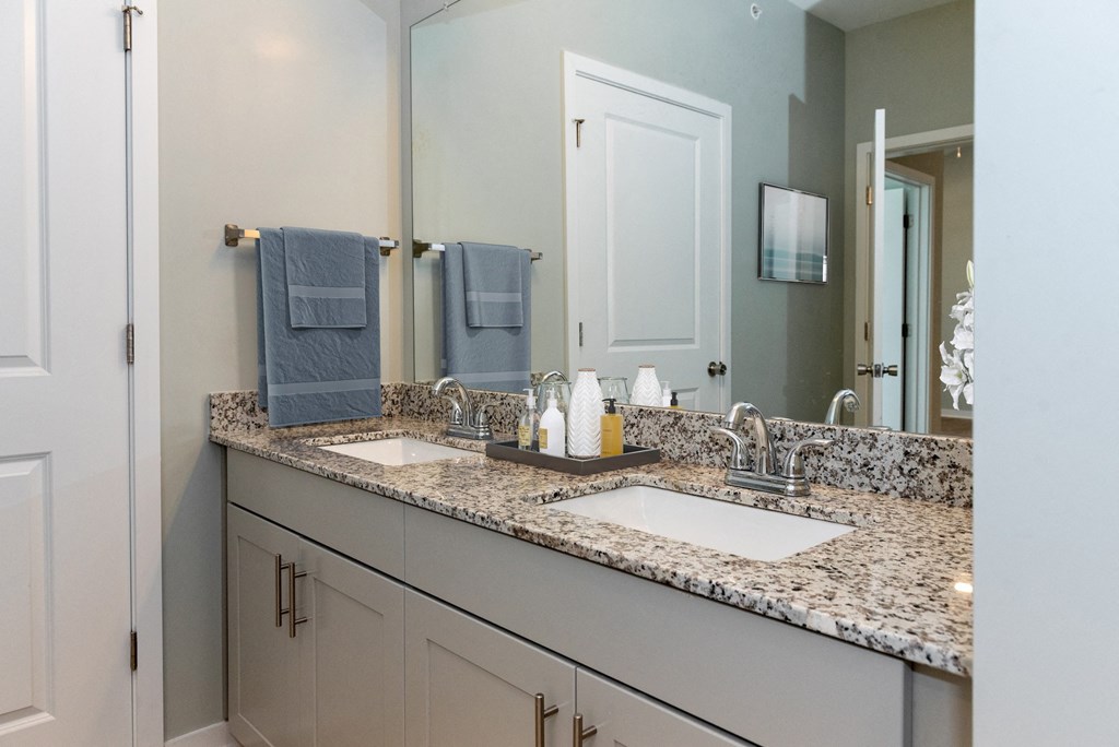 a bathroom with two sinks and a large mirror