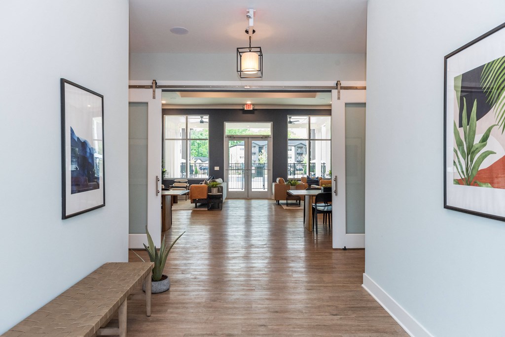 a view of the lobby of a building with tables and chairs