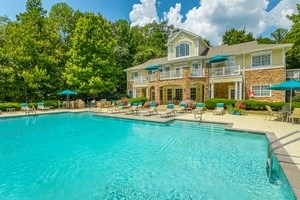 a large swimming pool in front of a large house