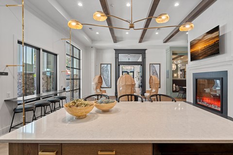 A modern kitchen with a large island and a fireplace.