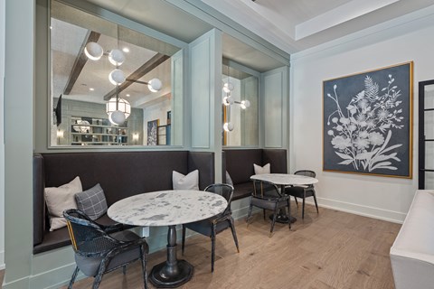 A dining area with round tables and bench seating.
