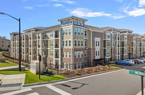 Exterior complex view from the corner with a street crosswalk.