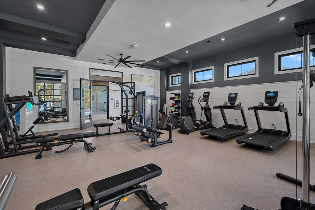 A spacious indoor gym with a variety of exercise equipment.