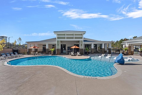 A large swimming pool in front of a building.