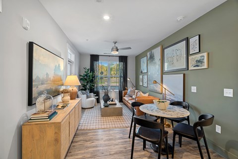 A living room with a table and chairs.