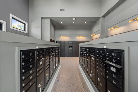 A long hallway with a series of mailboxes on either side.
