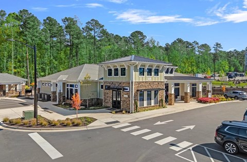 Exterior building with a parking lot in front of it and street view.