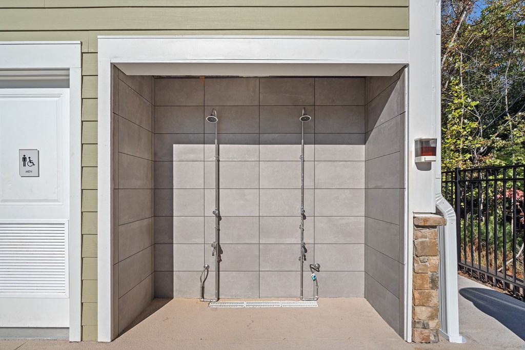 Two outdoor showers with opening for entrance.