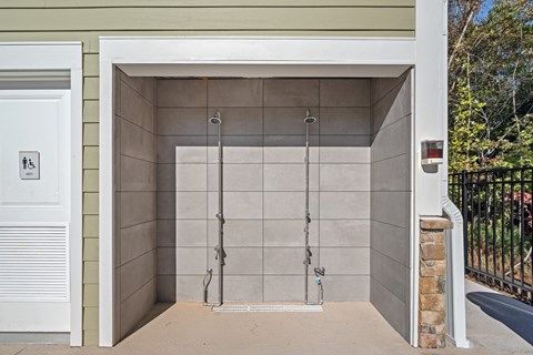 Two outdoor showers with opening for entrance.