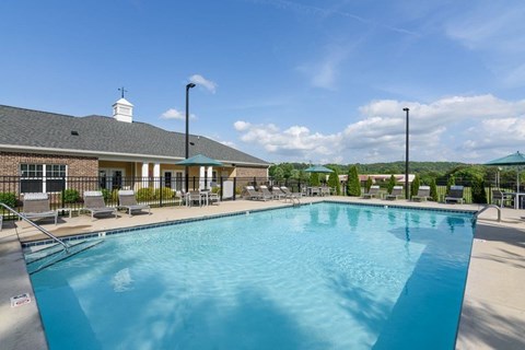A large swimming pool in front of a building.