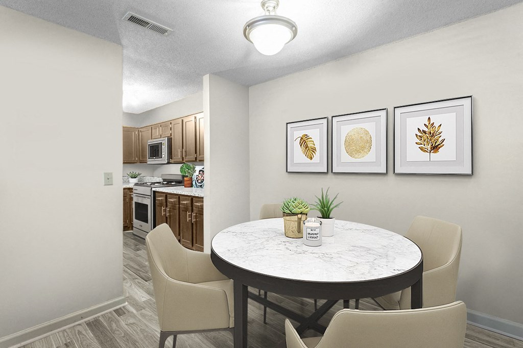 a dining area with a round table and four chairs