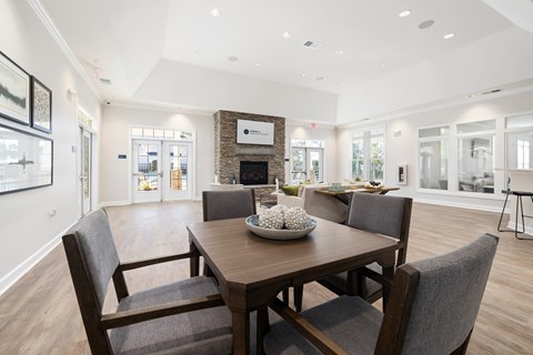 Eating Area in the Clubhouse with Four Chairs and a Table.
