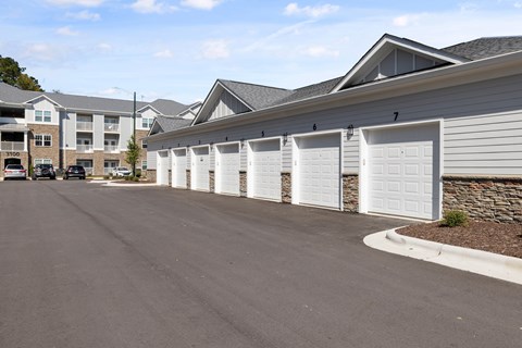 A Row of White Garage Doors Lined Up Within the Parking Lot.