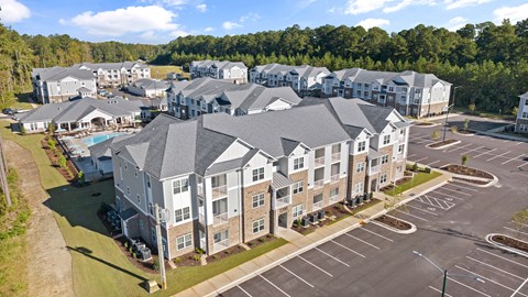 View of the Residential Complex with Multiple Buildings and a Parking Lot.