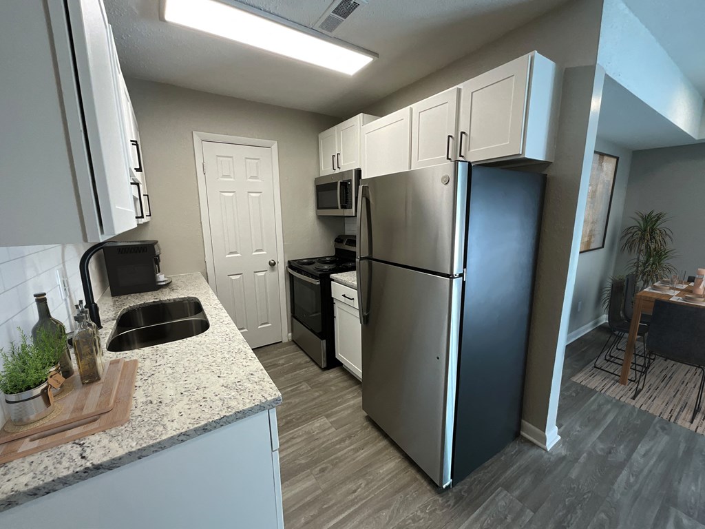 a kitchen with stainless steel appliances and a counter top