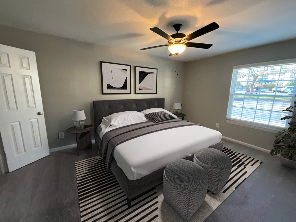 a bedroom with a large bed and a ceiling fan
