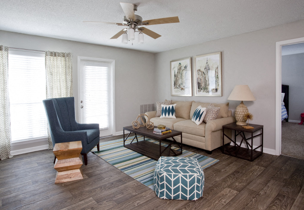 a living room with a couch and a ceiling fan