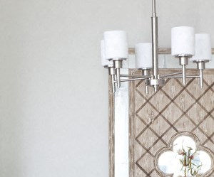 A dining table with four chairs and a chandelier at 1287 Shoals apartments in Athens, GA.