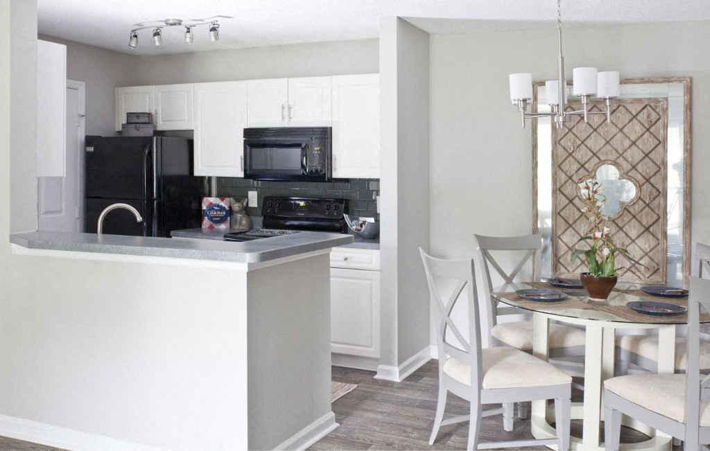 a kitchen and dining room with a table and chairs