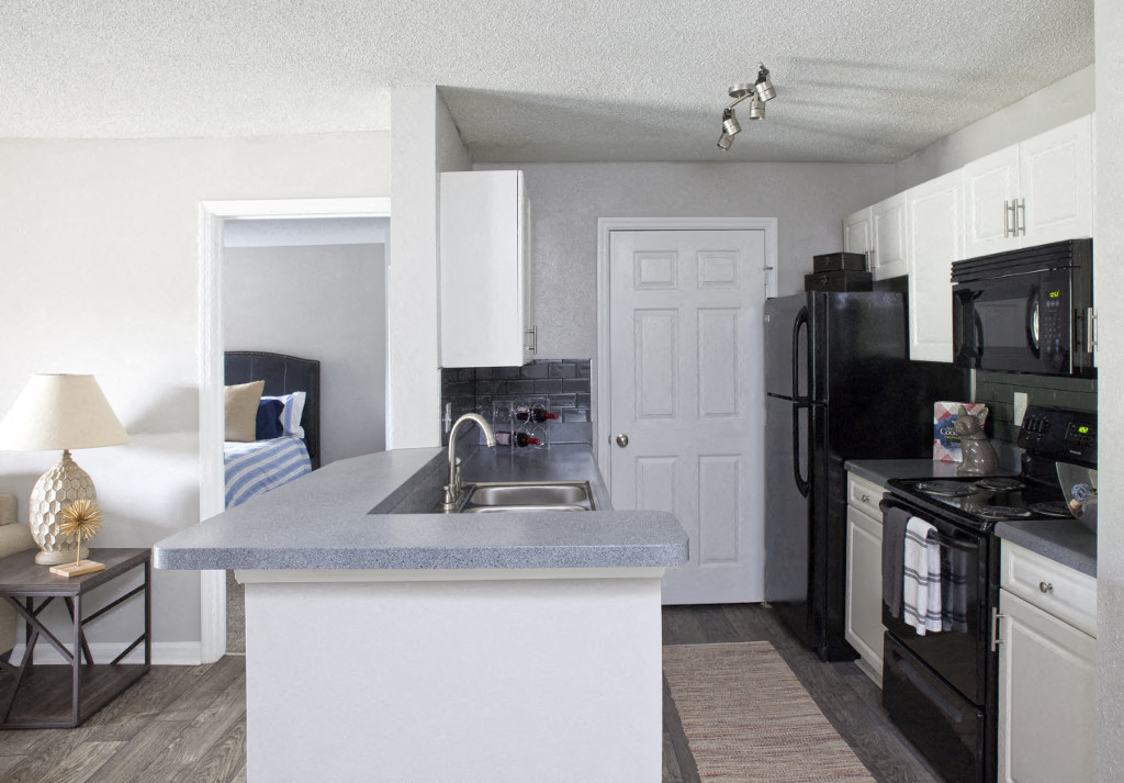 a kitchen with a sink and a refrigerator