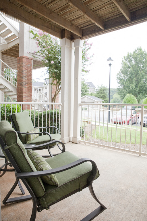 a porch with rocking chairs and a porch swing