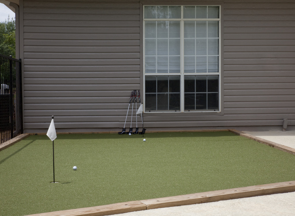 a putting lawn in front of a house