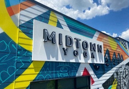 a mural on the side of a building with the word midtown yoga on it