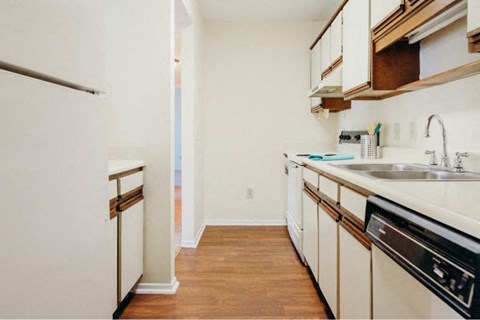 a kitchen with white cabinets and a sink