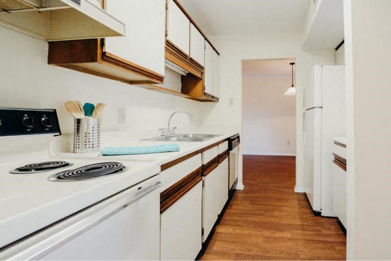 a kitchen with a white stove and a sink