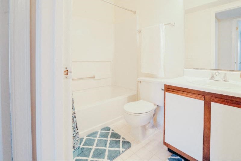a white bathroom with a toilet and a sink