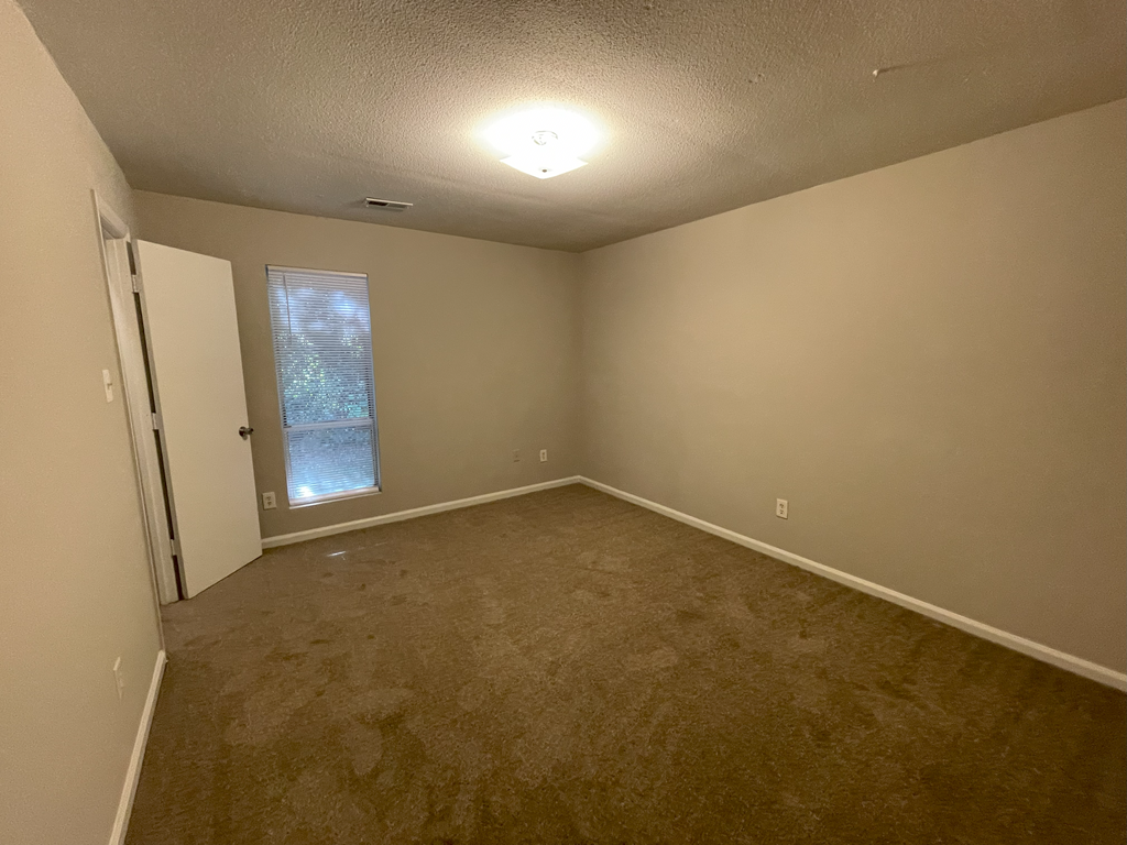 classic bedroom with tan carpeting