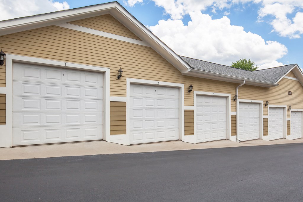 a row of three garage doors on the side of a building