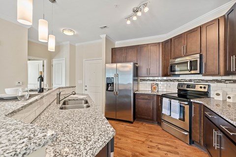 a kitchen with granite counter tops and stainless steel appliances