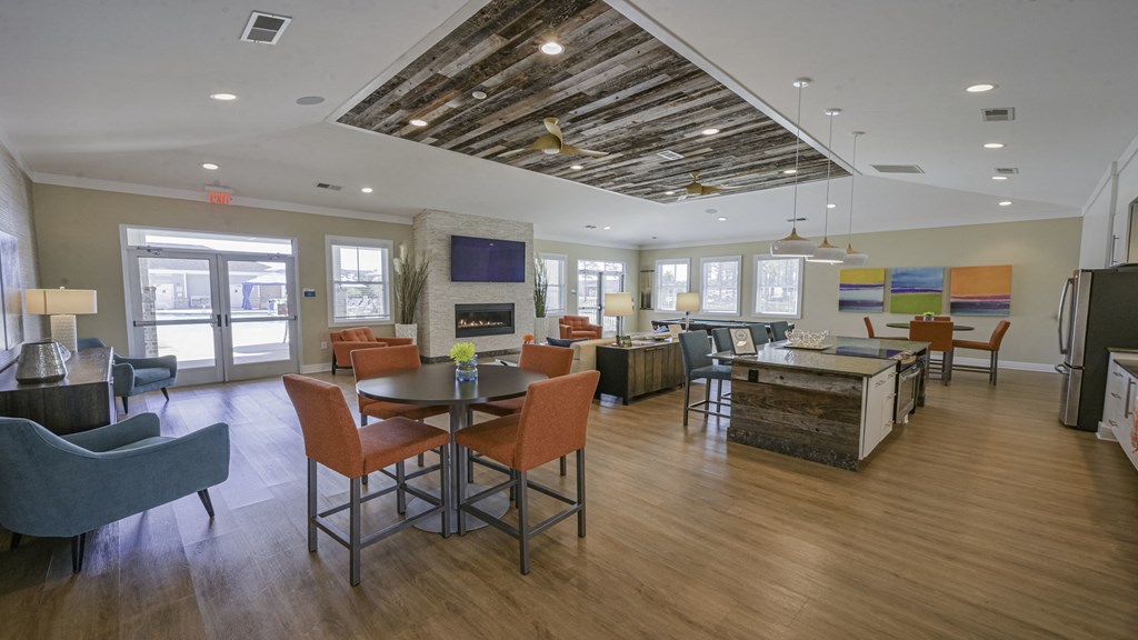 a living room with a table and chairs and a fireplace