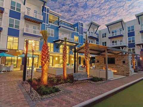 an exterior view of an apartment building at night