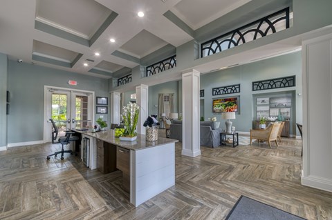 A spacious office with a reception desk and a waiting area with chairs.