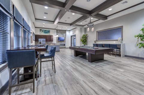 A modern dining room with a wooden floor and a large table.