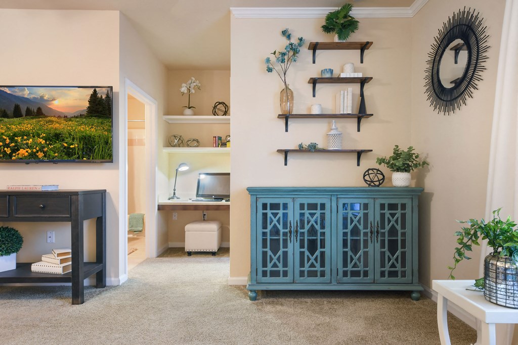 a screenshot of a room with a staircase and a wall with a clock and plants