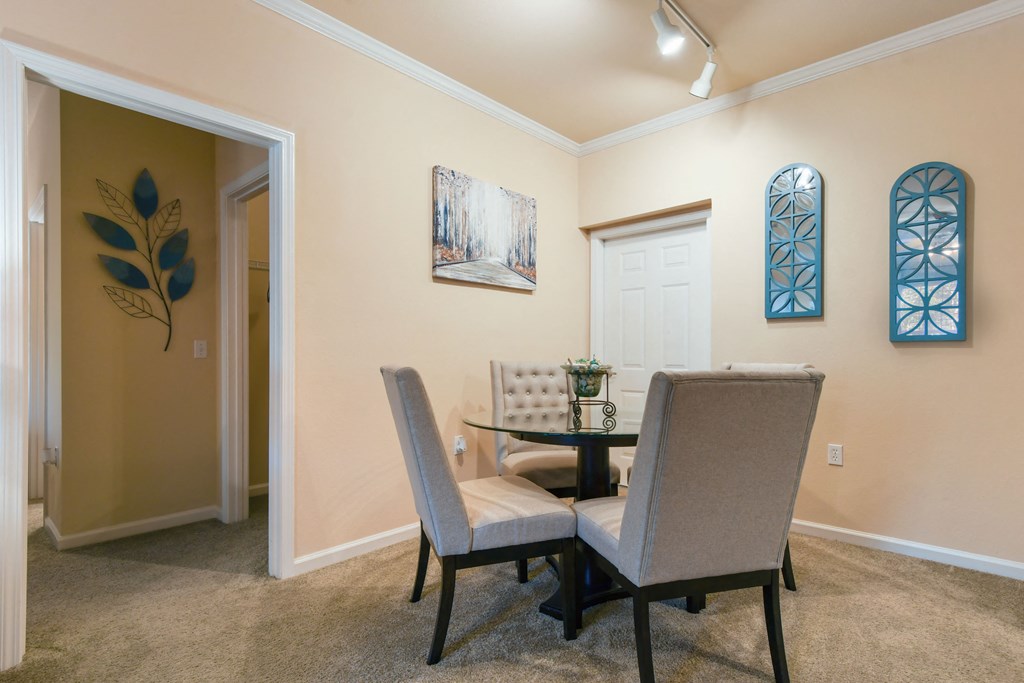 a dining room with a table and chairs