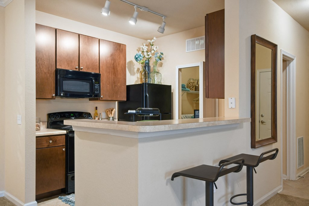a kitchen with a counter top and a microwave and a sink