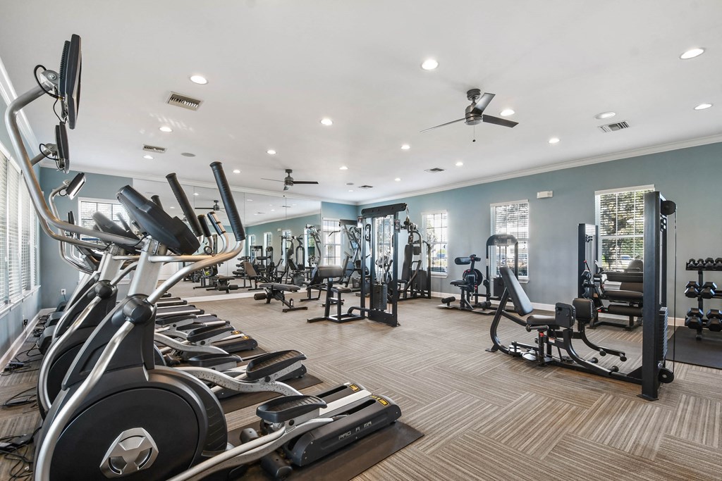 a gym with cardio machines and other exercise equipment
