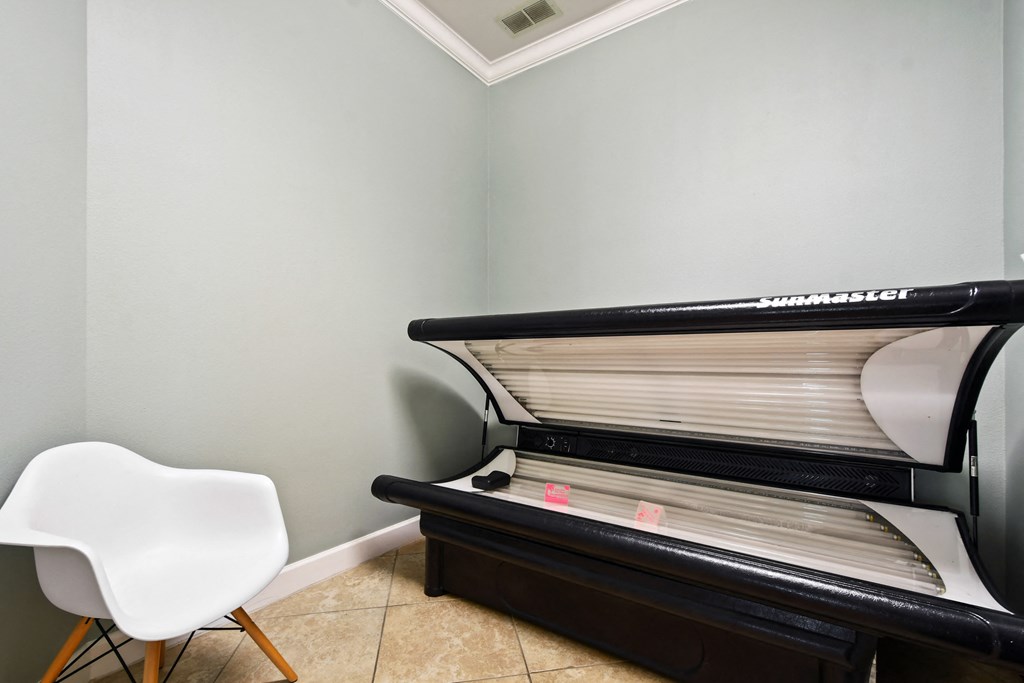 an empty heater in a room with a white chair