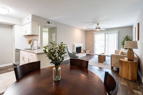 A dining room with a wooden table and chairs.