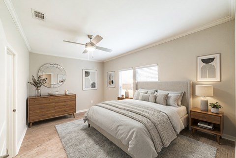 A bedroom with a large bed, a dresser, and a mirror.
