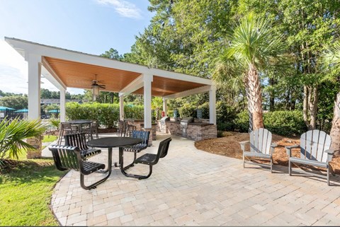 a patio with chairs and tables and a pavilion